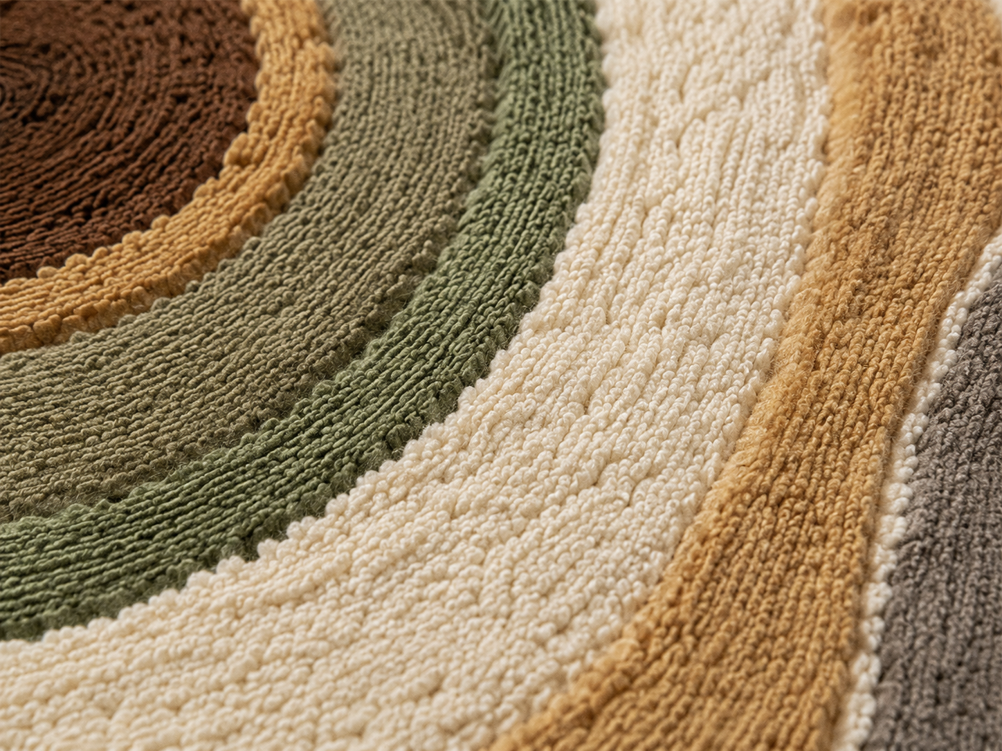 Close-up of the Terra Orbit contemporary area rug with concentric contour patterns in warm earthy tones.