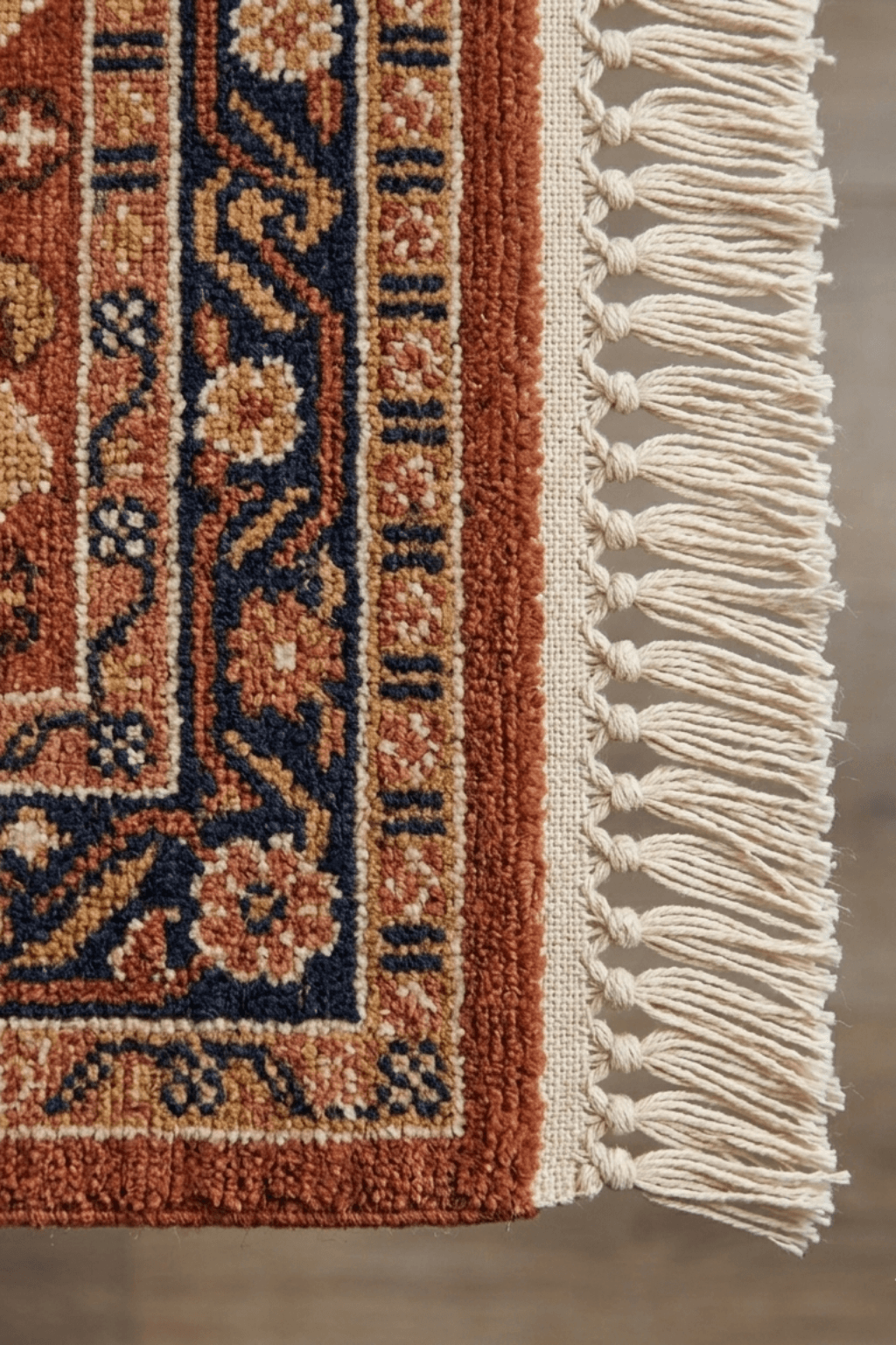 Close-up of the tribal geometric area rug showcasing intricate patterns and decorative fringes.