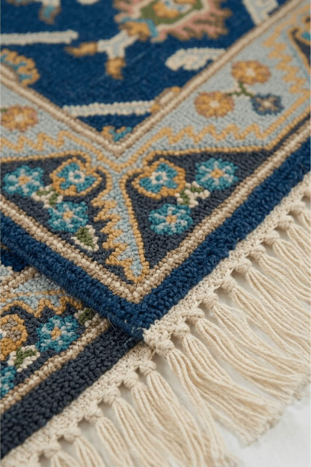 Close-up of Azure Heritage Medallion Rug showcasing intricate patterns and fringe detail on a vibrant blue background.