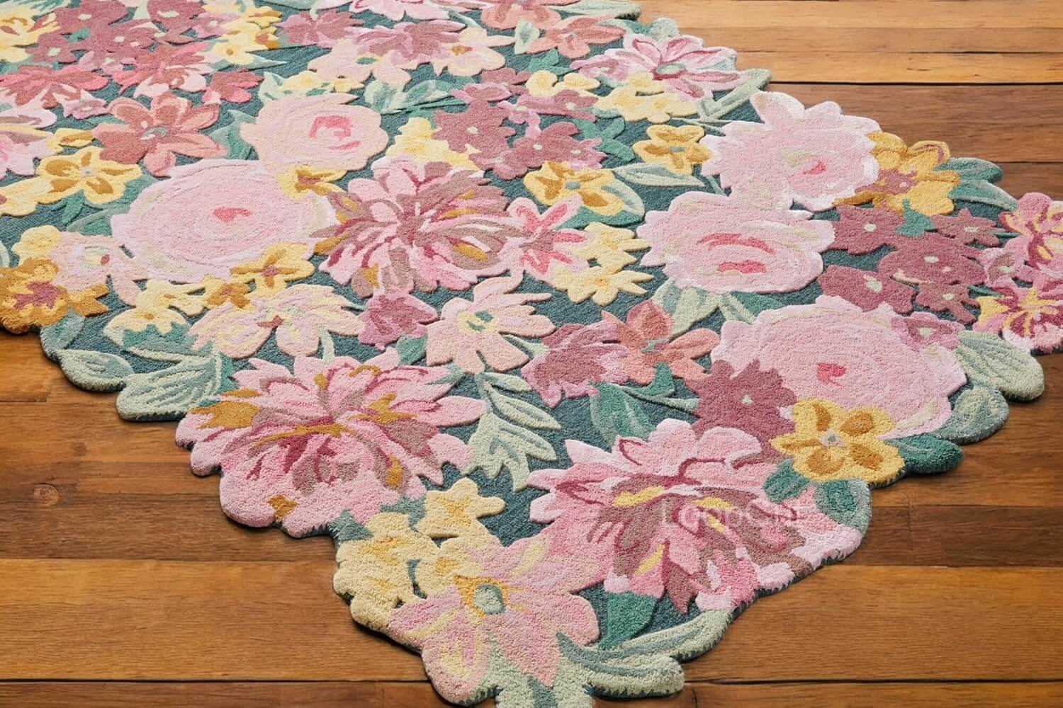 Sculpted floral rug featuring vibrant pink and yellow flowers on a blue background, perfect for home decor.