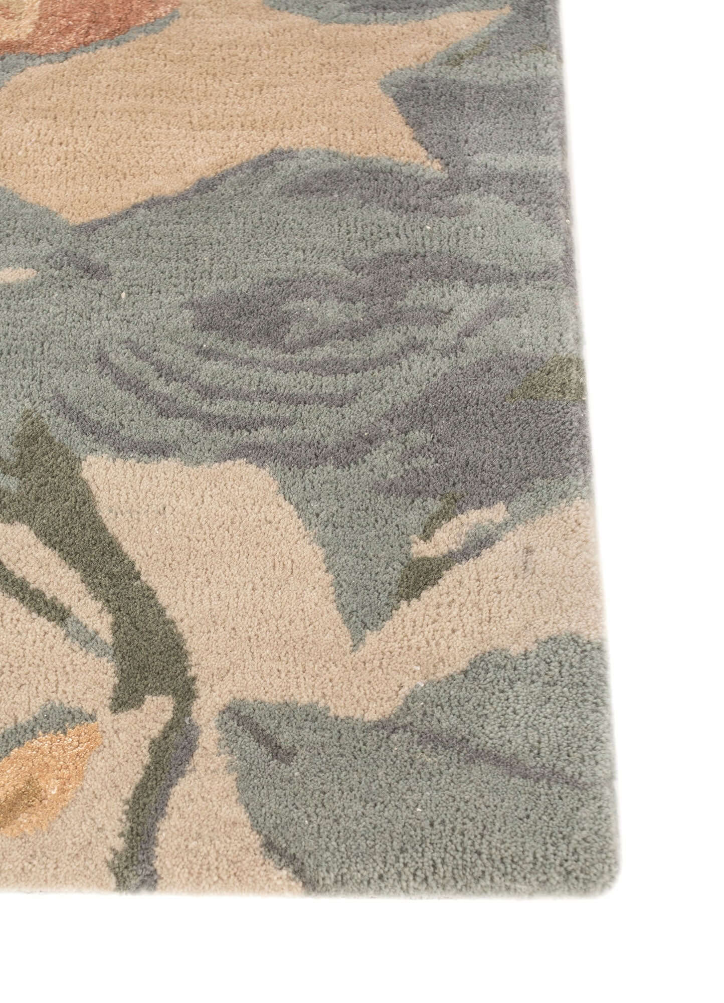 Hand tufted blue haze rug featuring floral and tropical designs in soft wool and viscose blend.