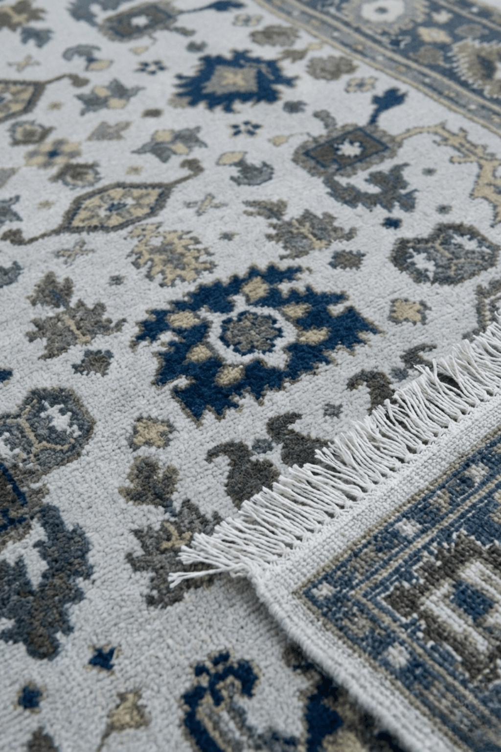 Artisan hand-knotted wool rug featuring intricate Persian motifs and a modern color palette.