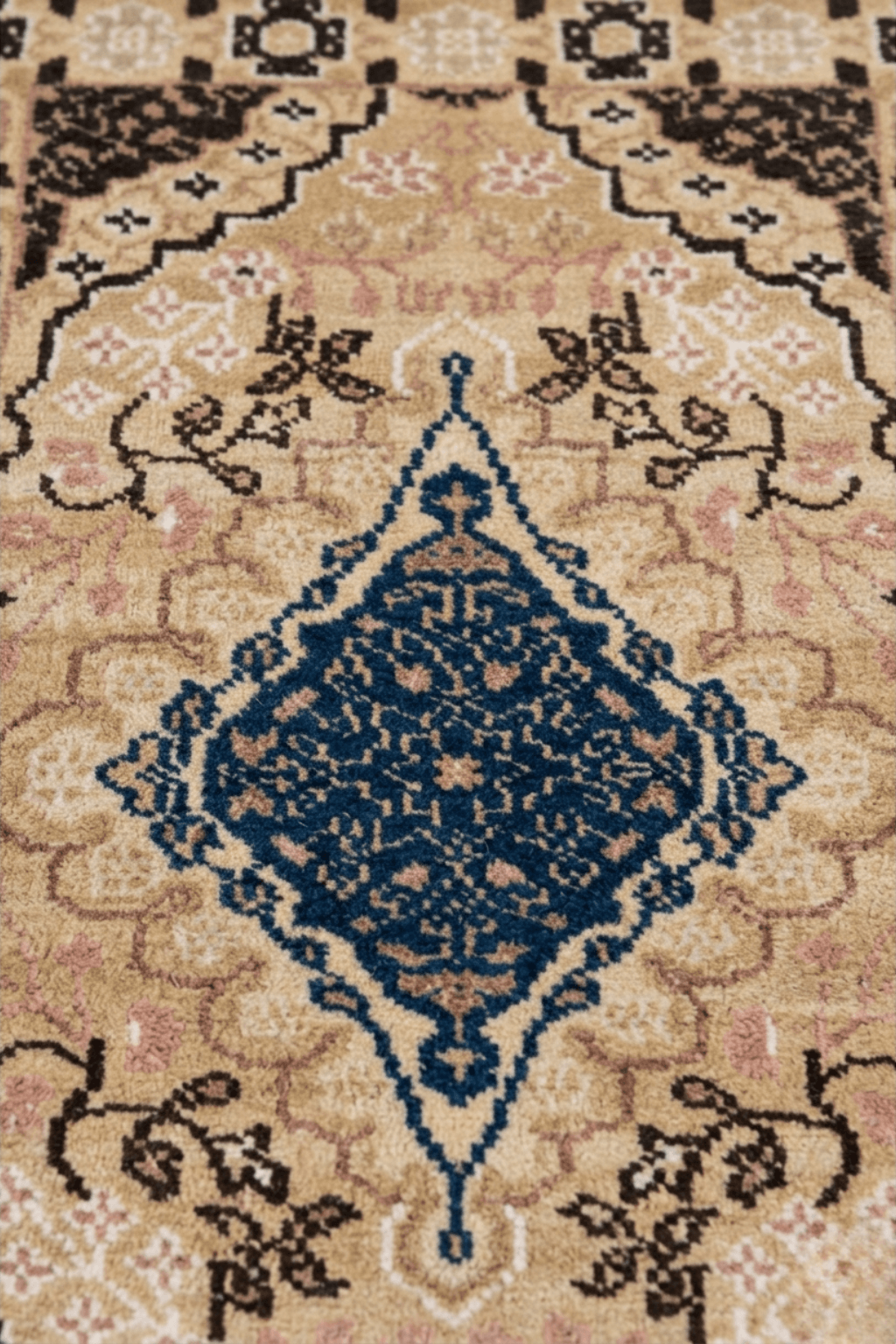 Elegant medallion wool area rug featuring intricate designs in navy blue, sand, camel, and muted rose tones.