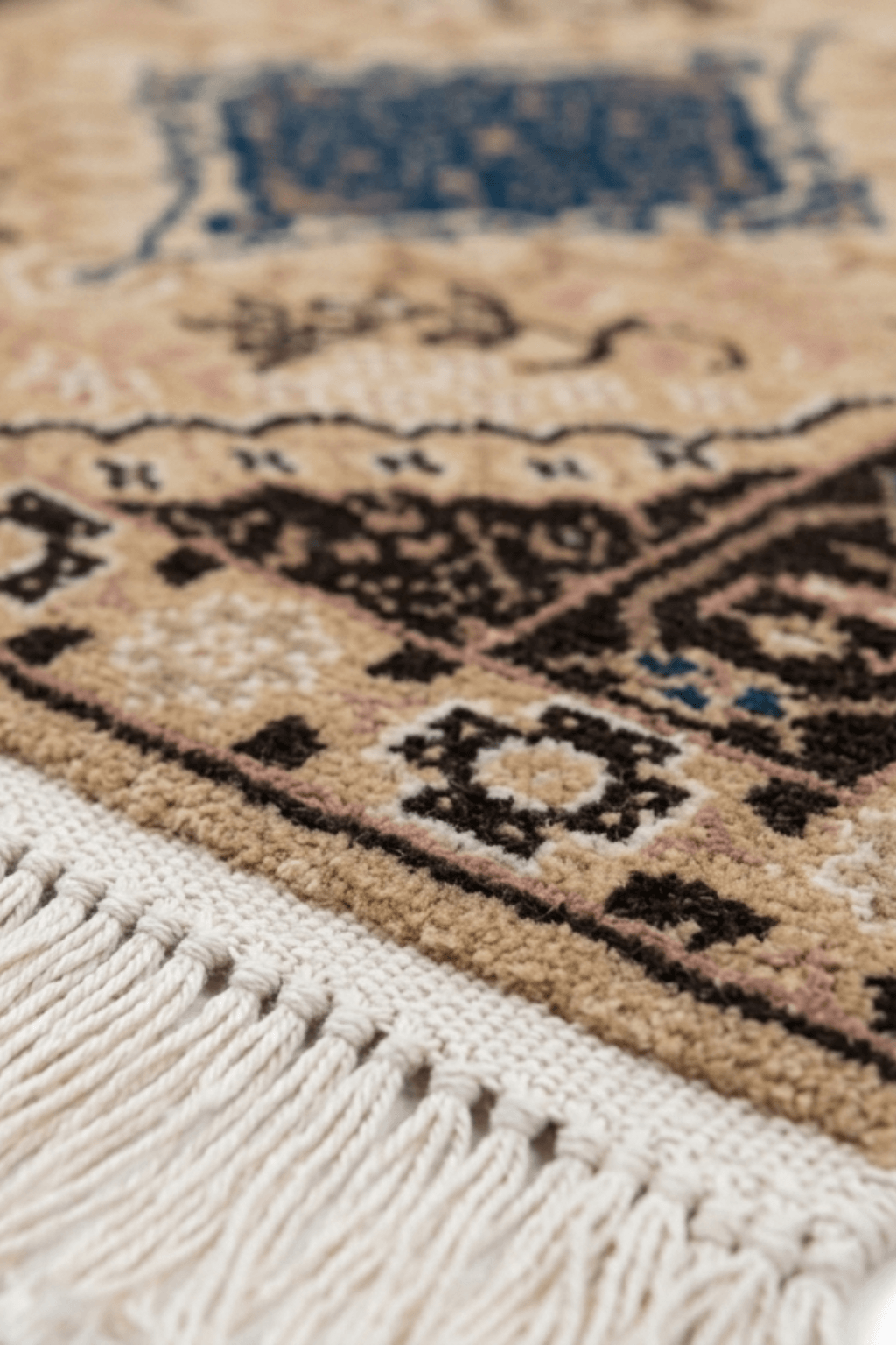 Elegant medallion wool area rug showcasing intricate details and soft earthy tones.