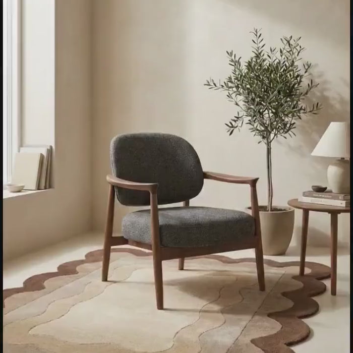 Cozy setting featuring the Cocoa Contour Scallop Rug with a stylish chair and greenery.