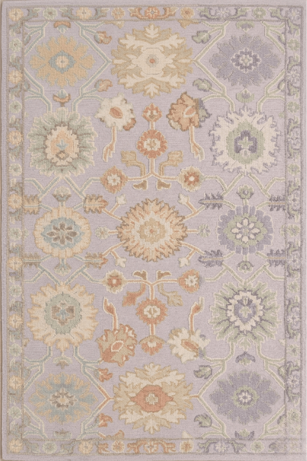 Seraphina hand-knotted wool rug featuring oversized botanical medallions and soft geometric borders in pastel colors.