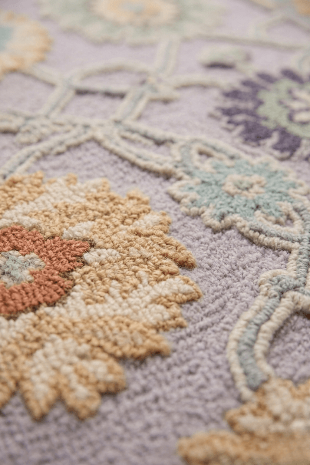 Close-up of the Seraphina hand-knotted wool rug featuring oversized floral patterns and soft geometric borders.