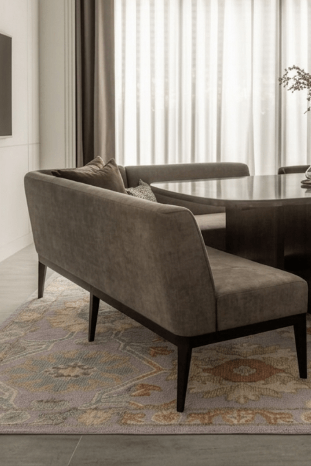 Elegant Seraphina hand-knotted wool rug under a modern dining table and sofa in a stylish interior.