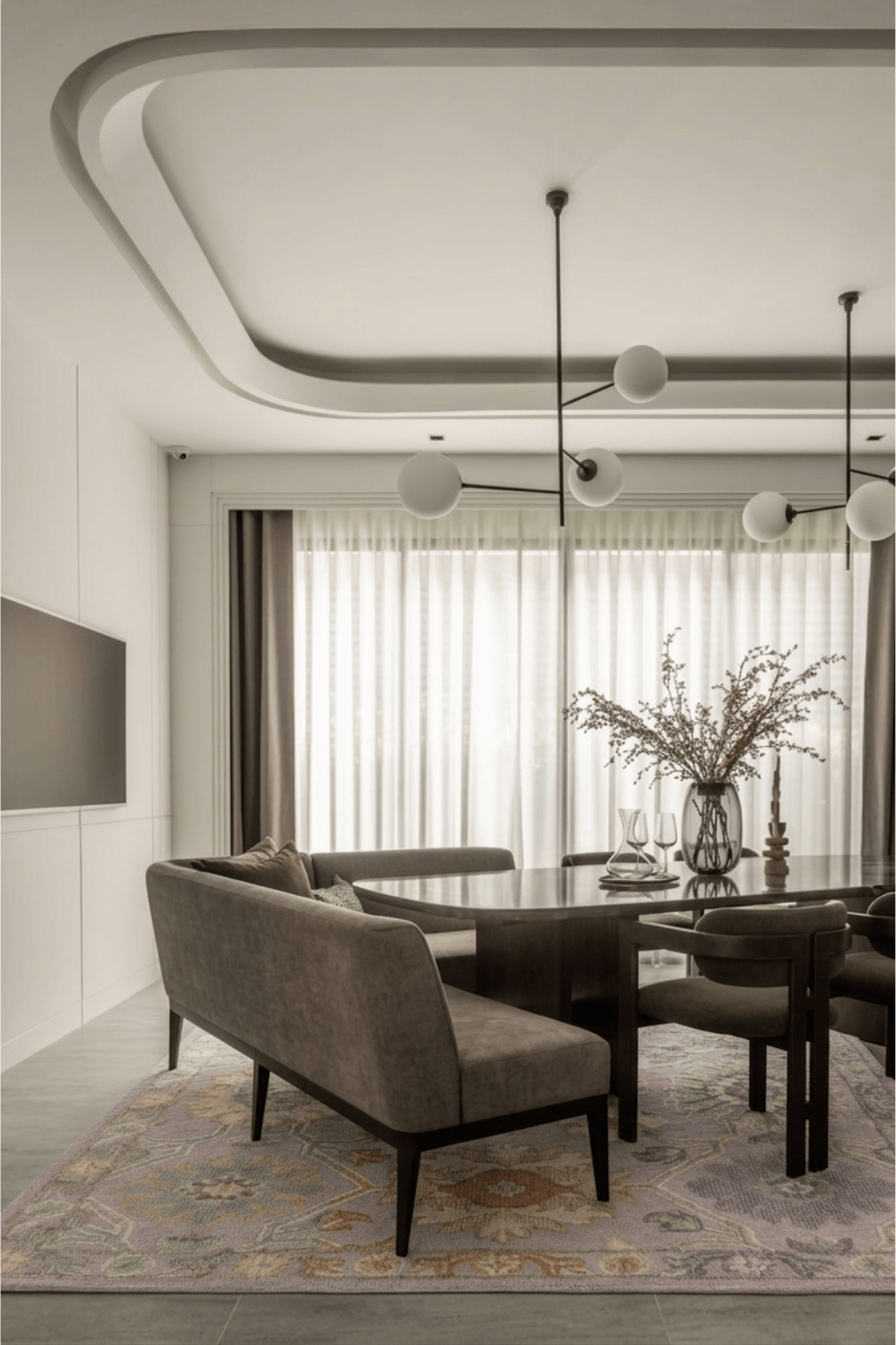 Stylish dining room featuring the Seraphina hand-knotted wool rug beneath a modern table and elegant furniture.