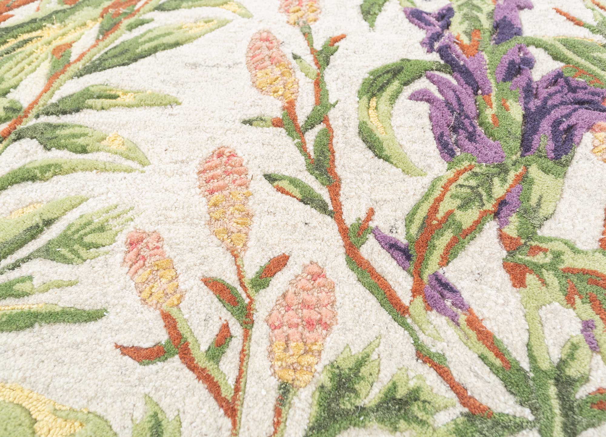 Detailed view of Treetop Hand-Tufted Rug featuring floral and tropical designs in vibrant colors.