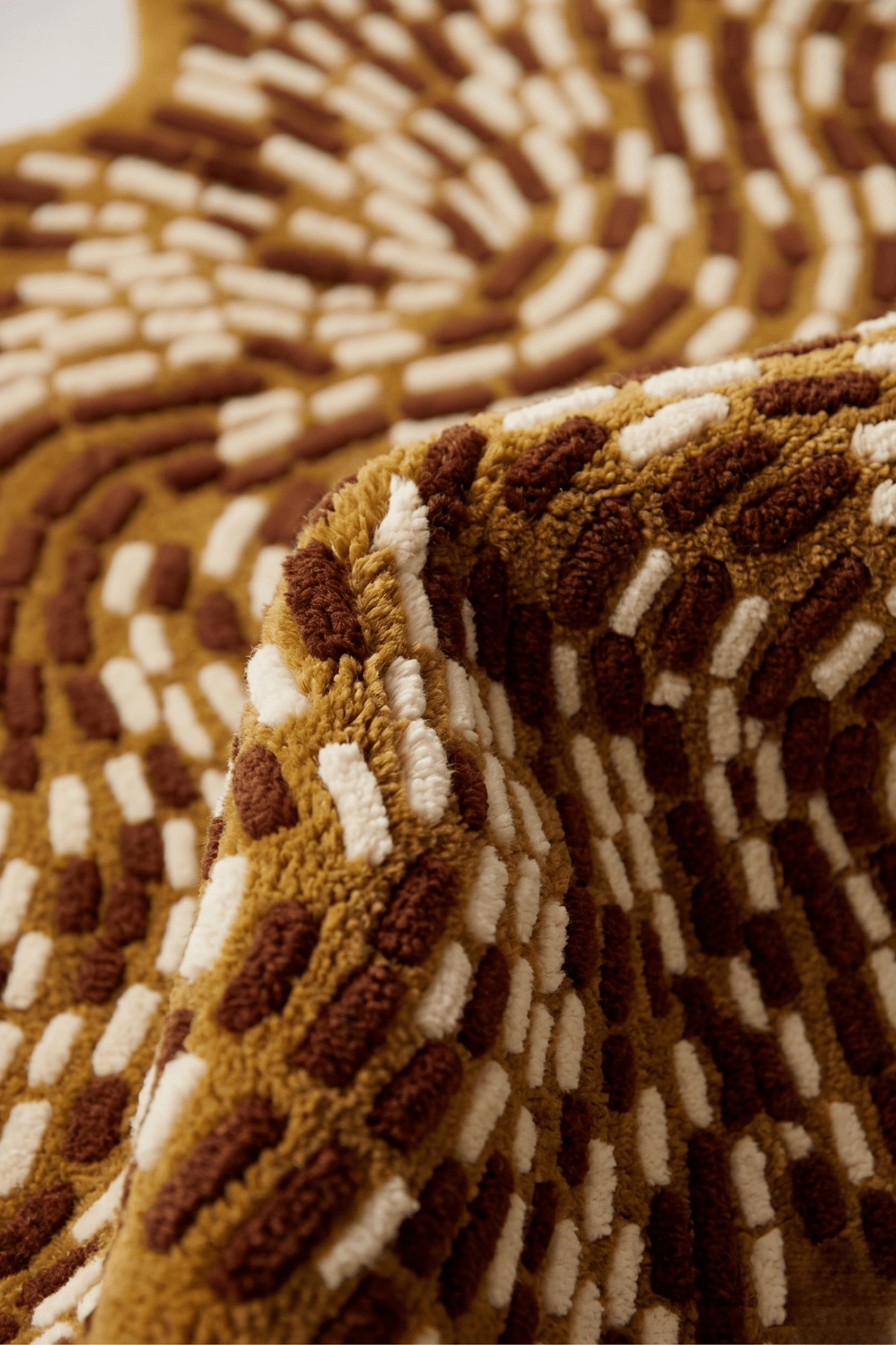 Wesboyeg Pulse kinetic floor decor rug showcasing its unique dashed-weave pattern in mustard-gold tones.