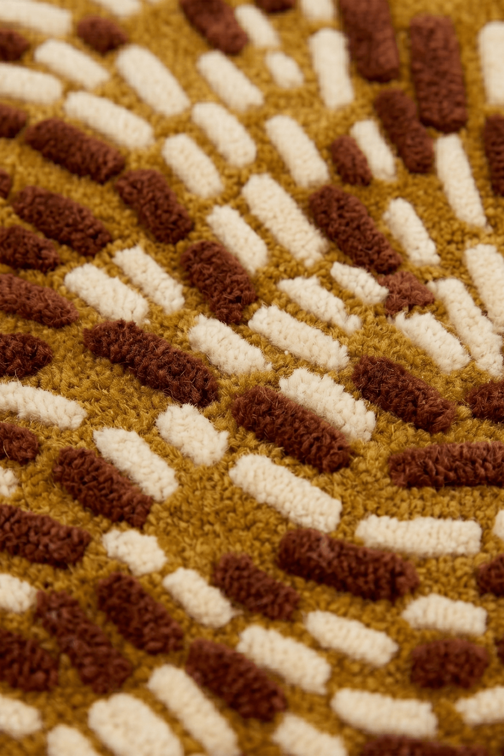 Wesboyeg Pulse rug showing staggered, dashed-weave pattern in mustard-gold and brown colors.